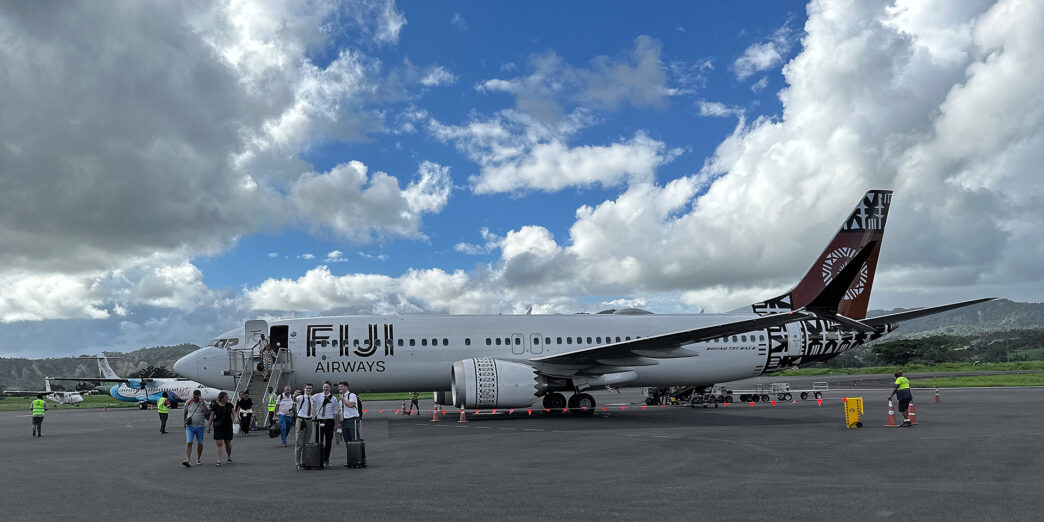 a group of people standing next to a large airplane