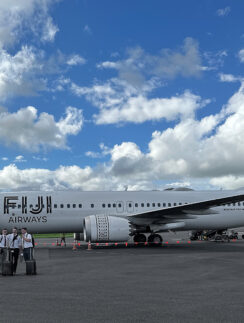 a group of people standing next to a large airplane