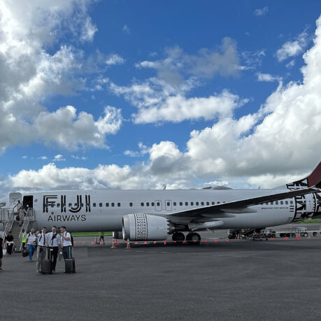 a group of people standing next to a large airplane