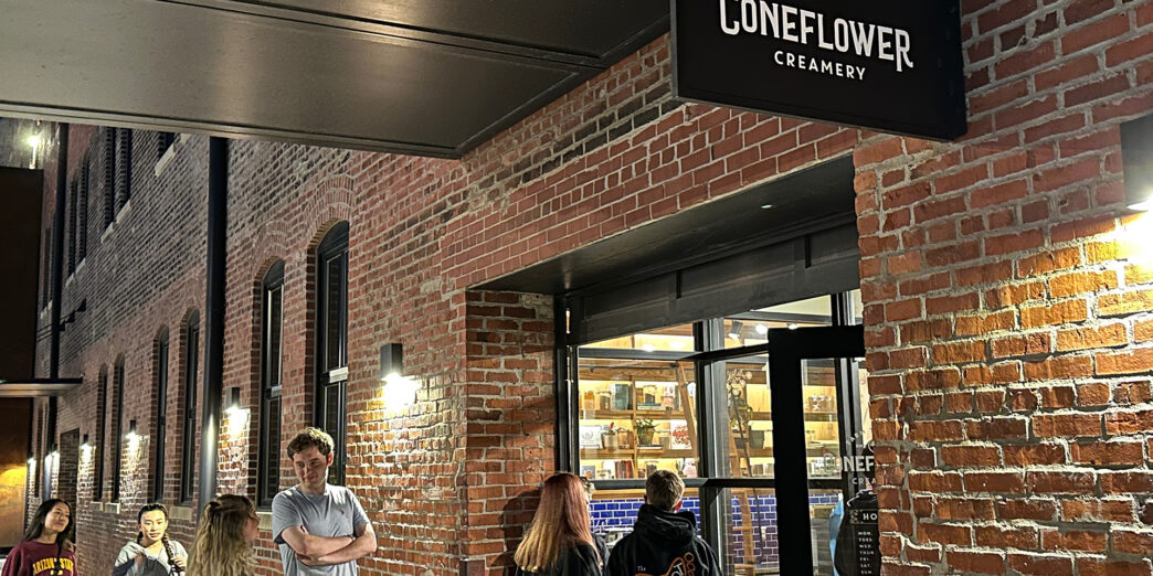 a group of people standing outside a store