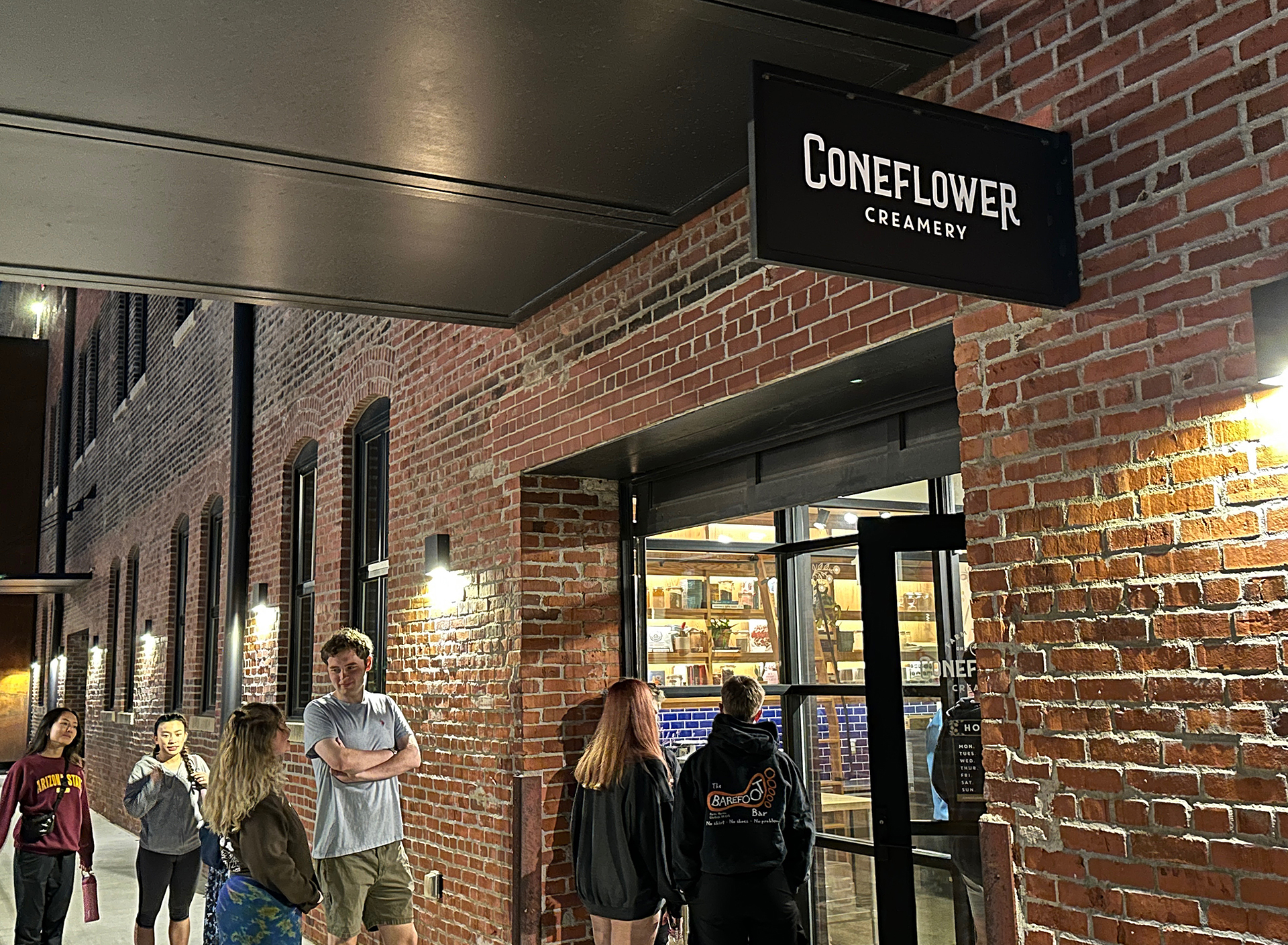 a group of people standing outside a store