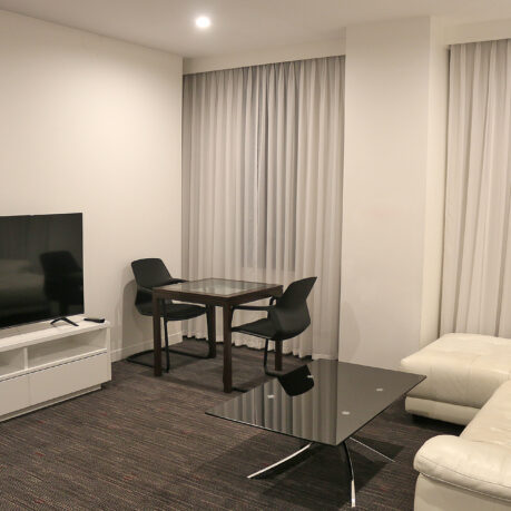 a room with a tv and couches