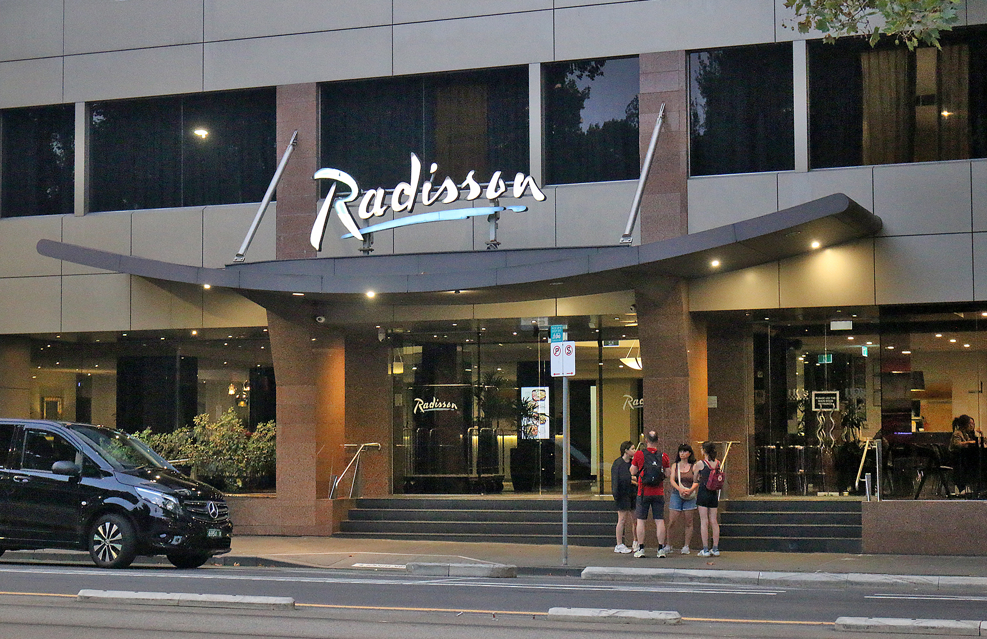 a group of people standing outside of a building