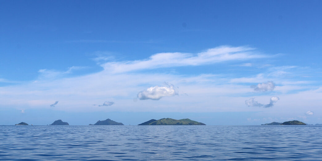 a body of water with islands in the distance