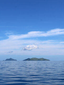 a body of water with islands in the distance