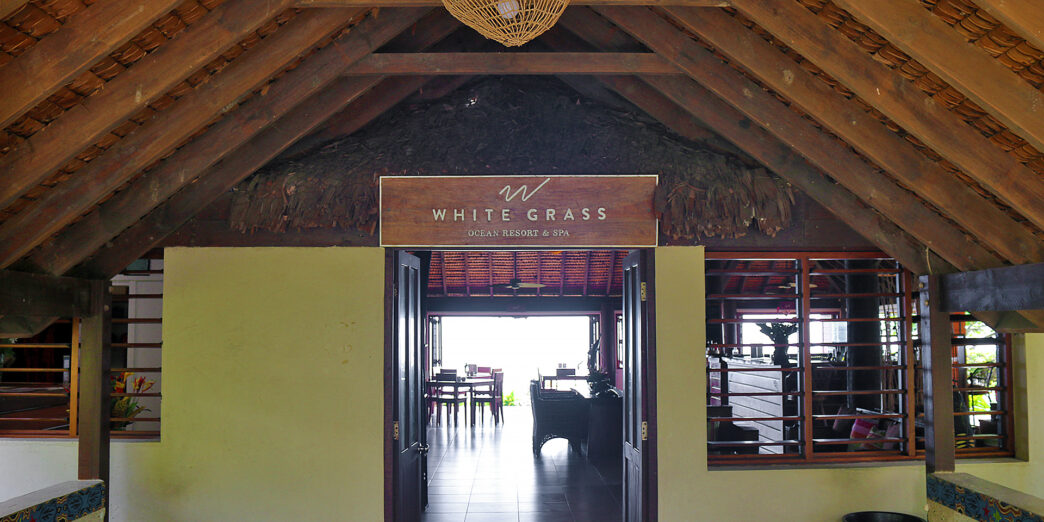 a room with a thatched roof and a sign