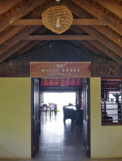 a room with a thatched roof and a sign