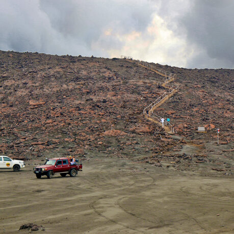 a group of cars on a dirt hill