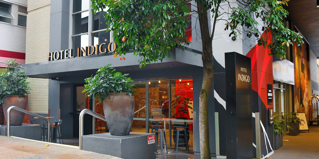 a building with a tree and a sign