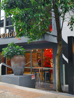 a building with a tree and a sign