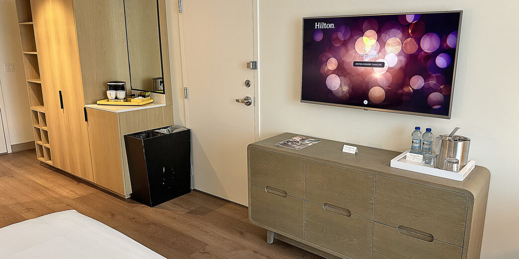 a room with a television and a dresser