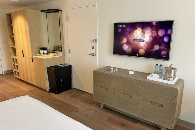 a room with a television and a dresser