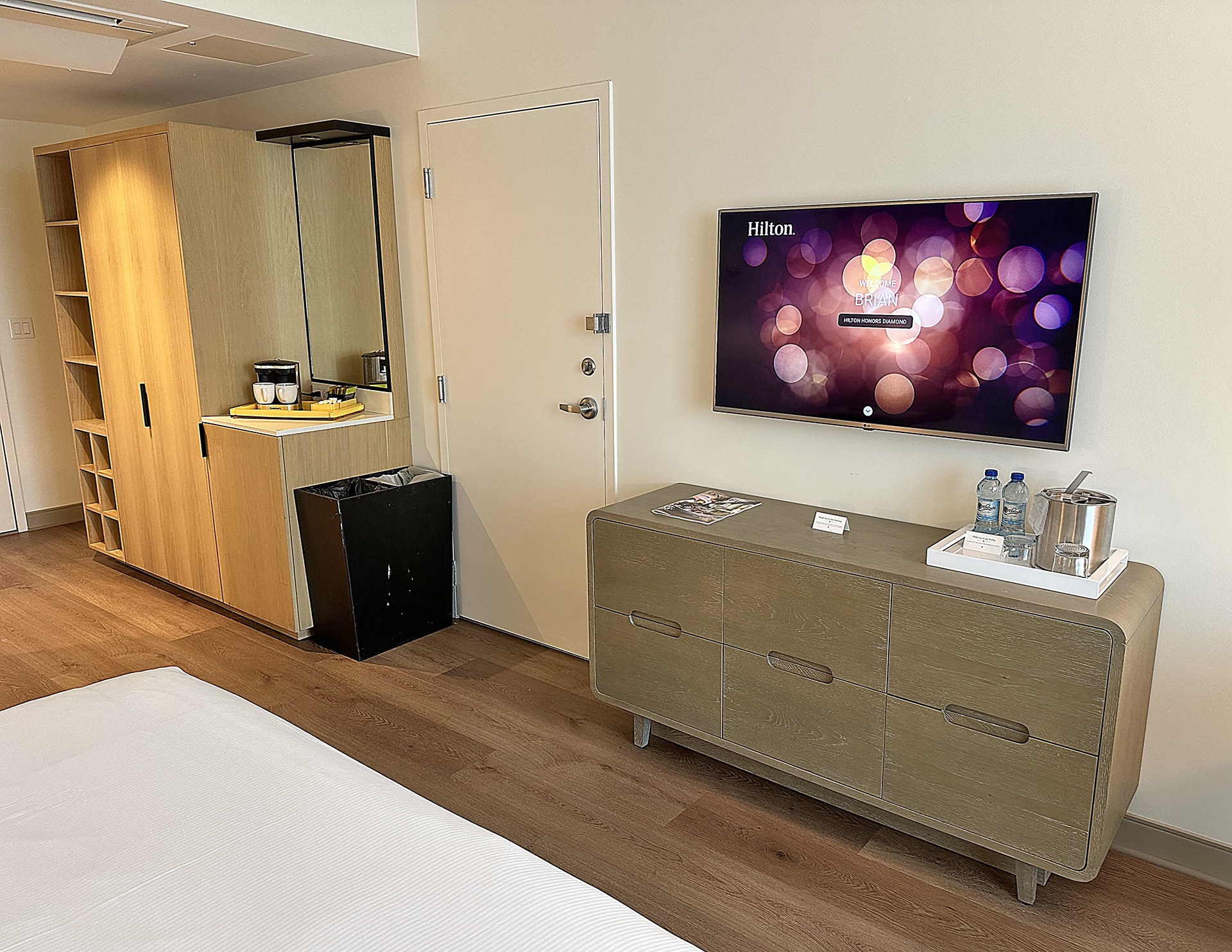 a room with a television and a dresser