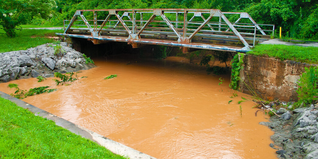 a bridge over a muddy river