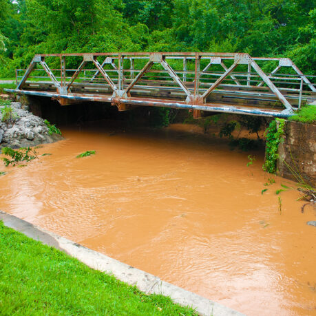 a bridge over a muddy river