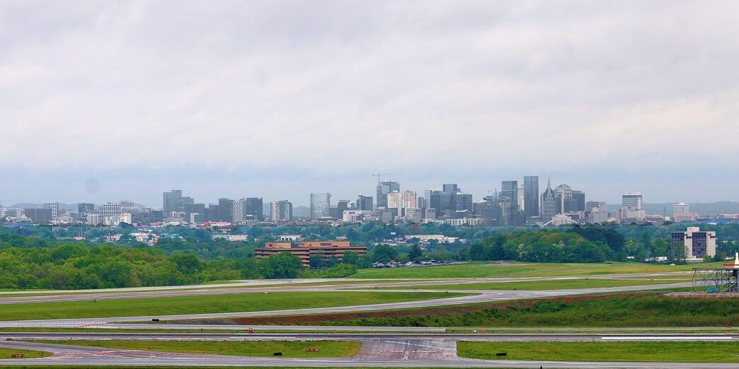 a runway with a city in the background