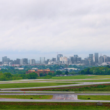 a runway with a city in the background