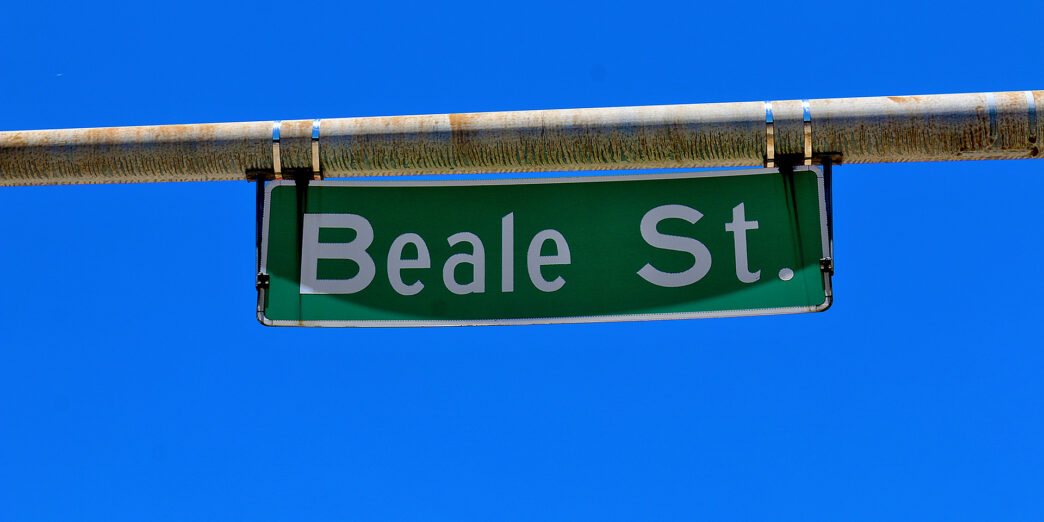 a green street sign with white text