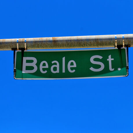 a green street sign with white text