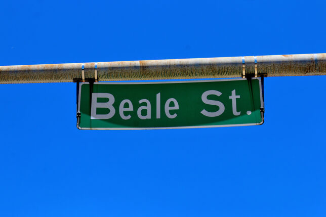 a green street sign with white text