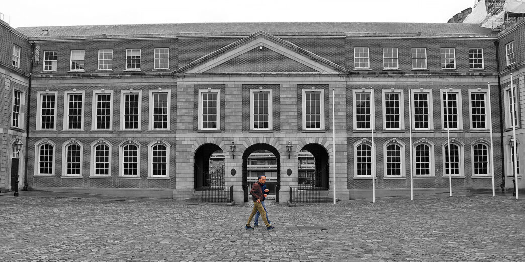 a man walking in front of a large building