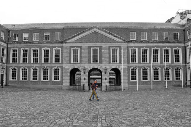 a man walking in front of a large building