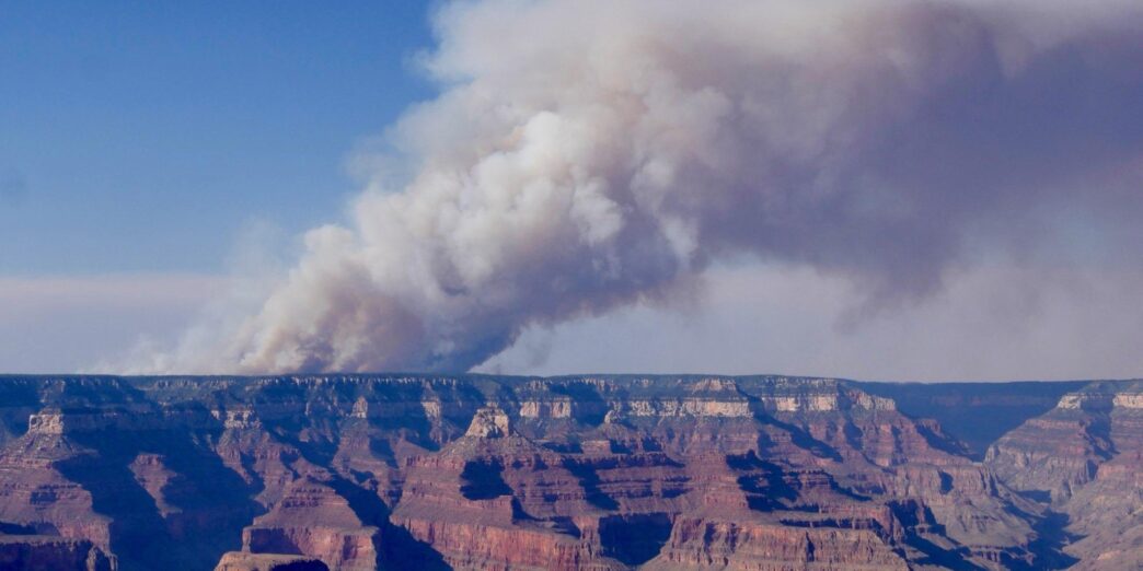 a large canyon with smoke coming out of it