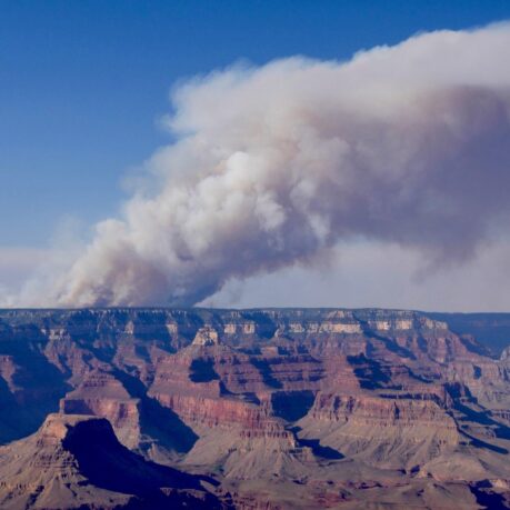 a large canyon with smoke coming out of it
