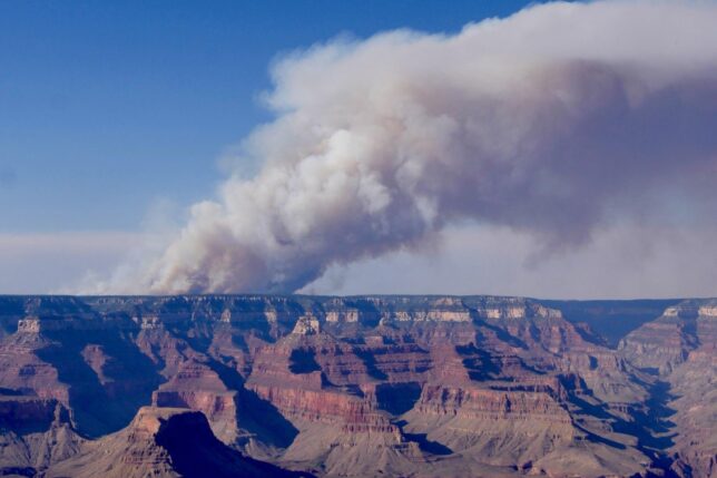 a large canyon with smoke coming out of it
