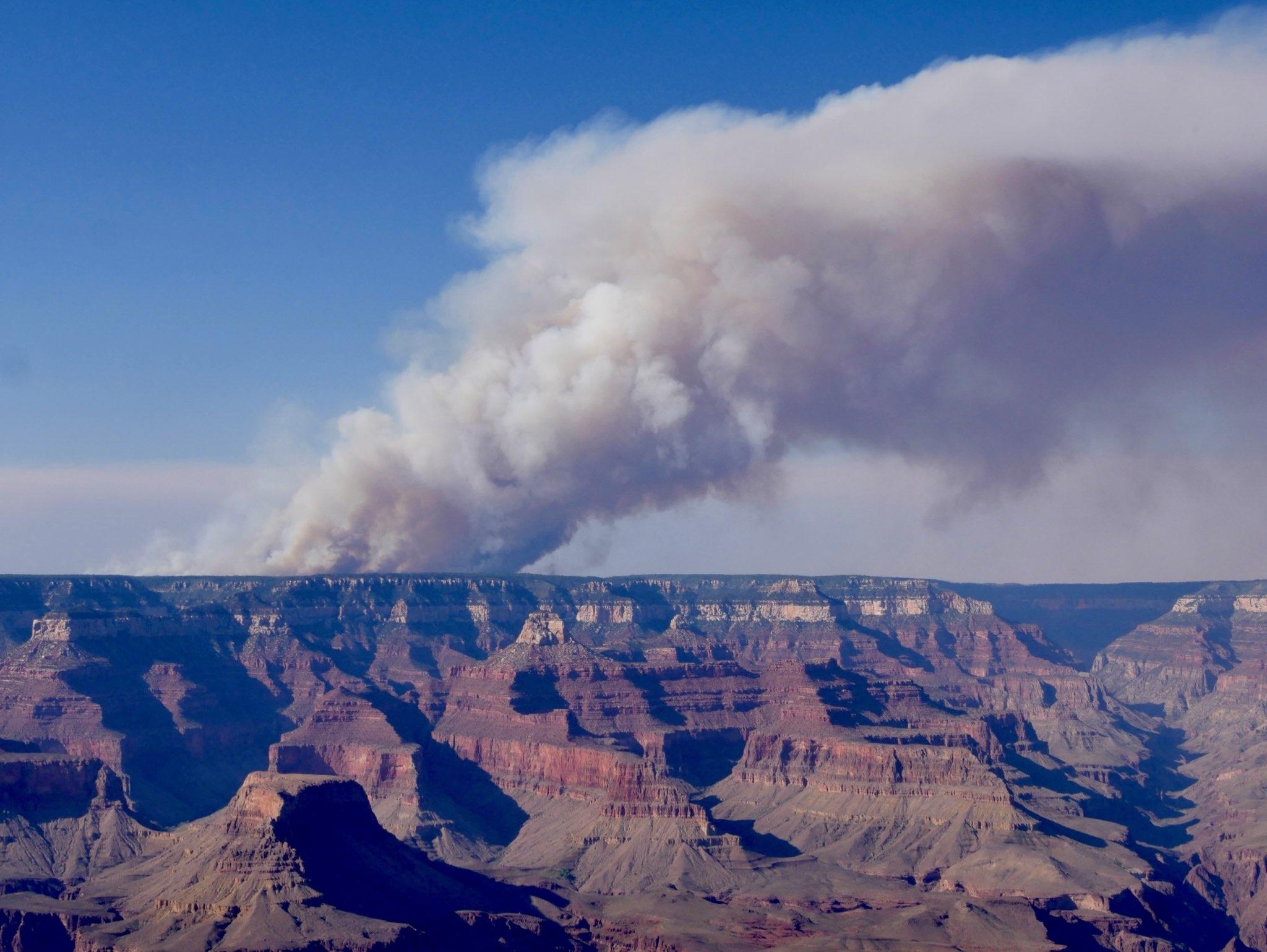 a large canyon with smoke coming out of it