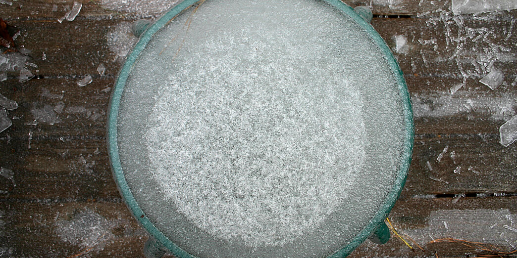 a round glass table with ice on top