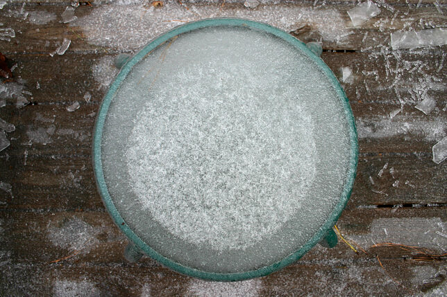 a round glass table with ice on top