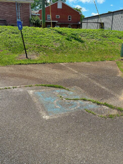 a concrete driveway with a hole in the ground