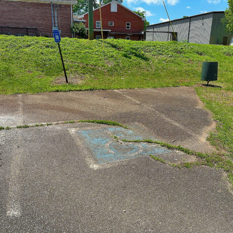 a concrete driveway with a hole in the ground