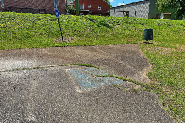 a concrete driveway with a hole in the ground