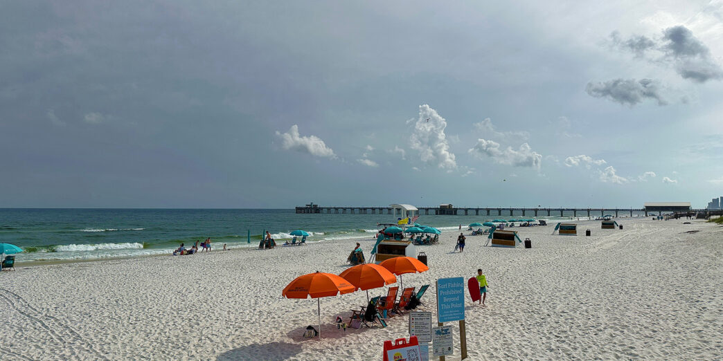 a beach with umbrellas and people on it
