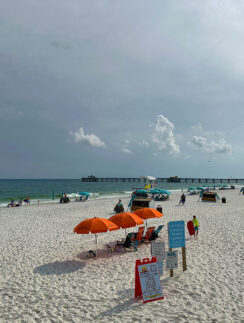 a beach with umbrellas and people on it