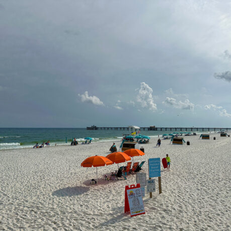 a beach with umbrellas and people on it