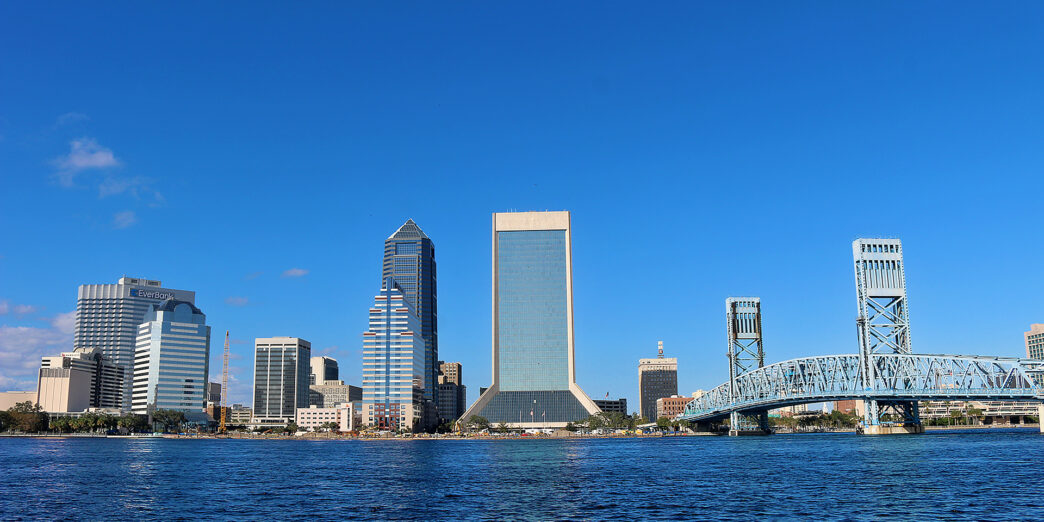 a city skyline with a bridge over water