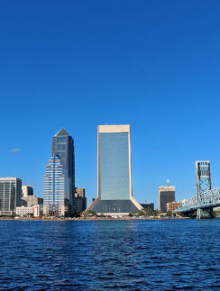 a city skyline with a bridge over water