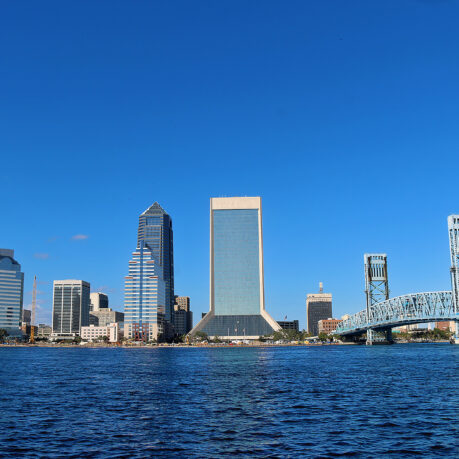 a city skyline with a bridge over water