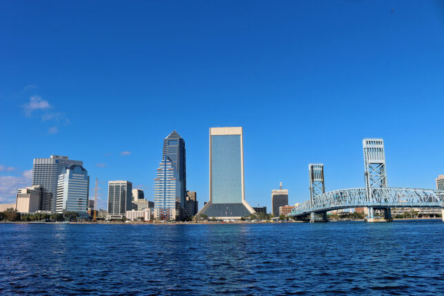 a city skyline with a bridge over water