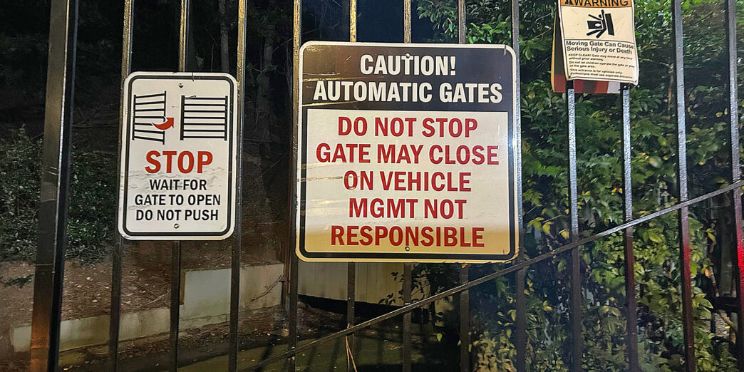a gate with signs on it