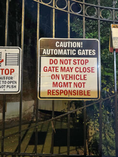 a gate with signs on it