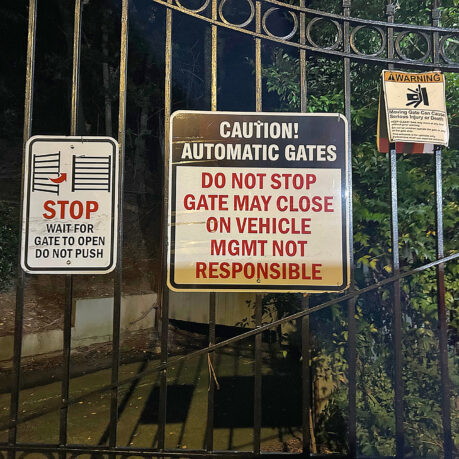 a gate with signs on it