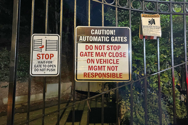 a gate with signs on it