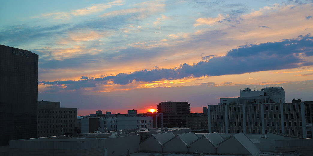 a sunset over a city