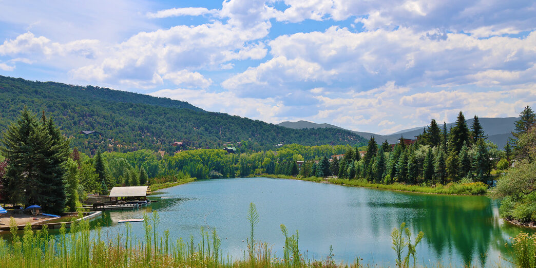 a lake surrounded by trees and mountains