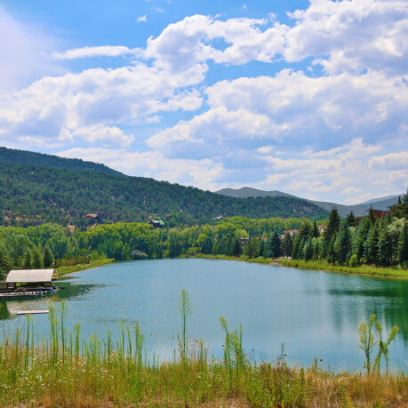 a lake surrounded by trees and mountains