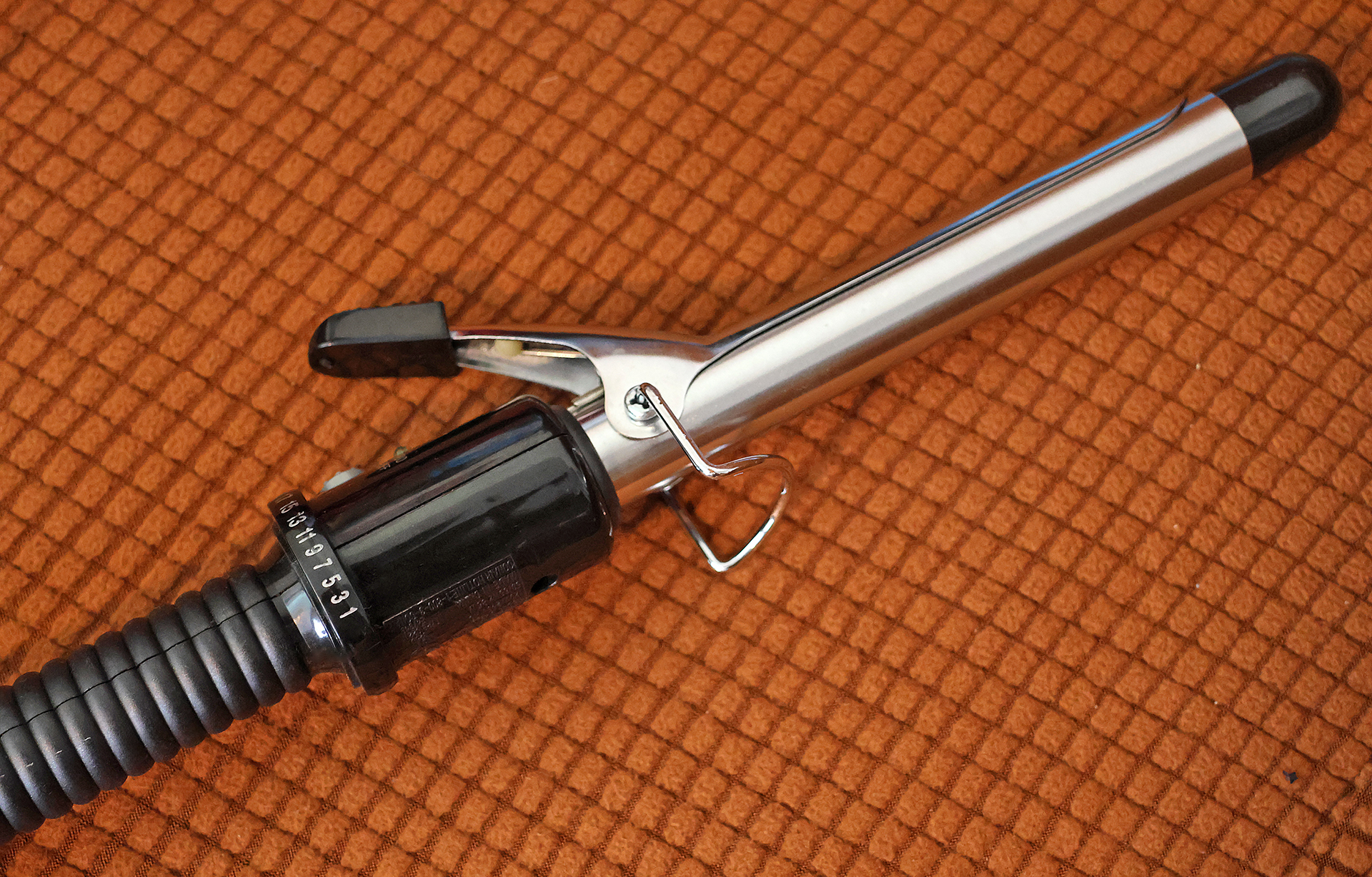 a curling iron on a carpet
